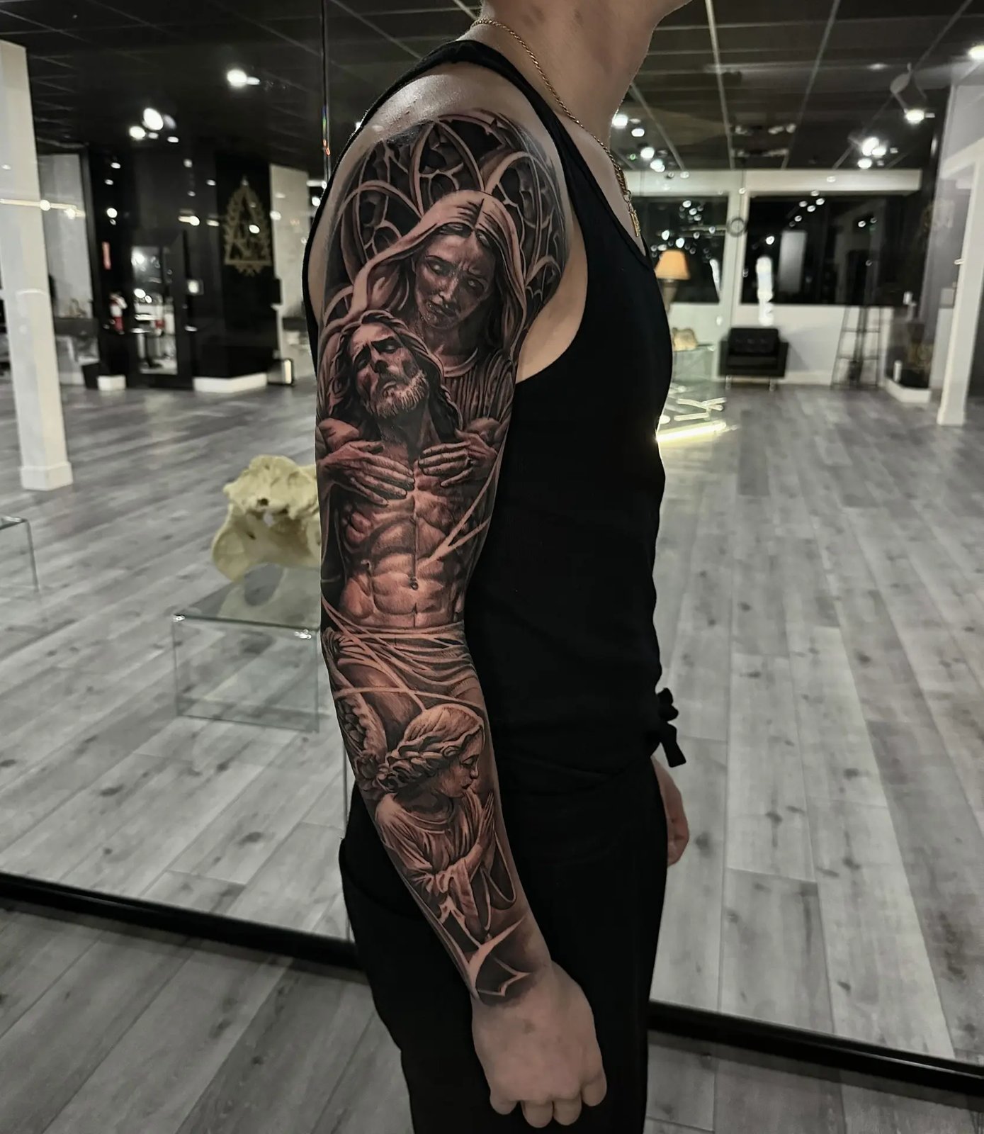 Black and grey religious sleeve with Mary holding Jesus